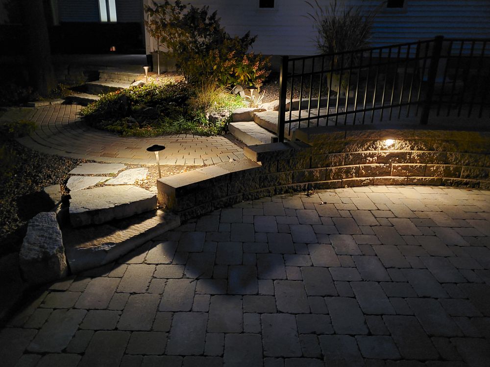 Full patio with railing, walkway, and landscape lighting
